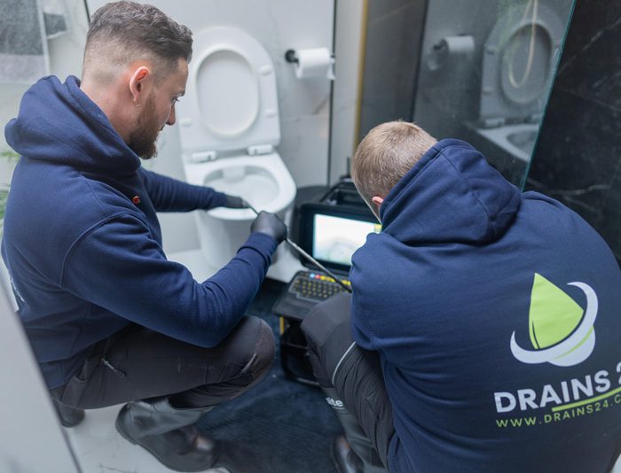 Drainage engineer carrying out drain repairs at a Twickenham property