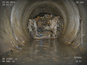 CCTV drain survey screen view showing a blocked drain pipe with standing water, debris and waste build-up during a Twickenham drainage inspection.